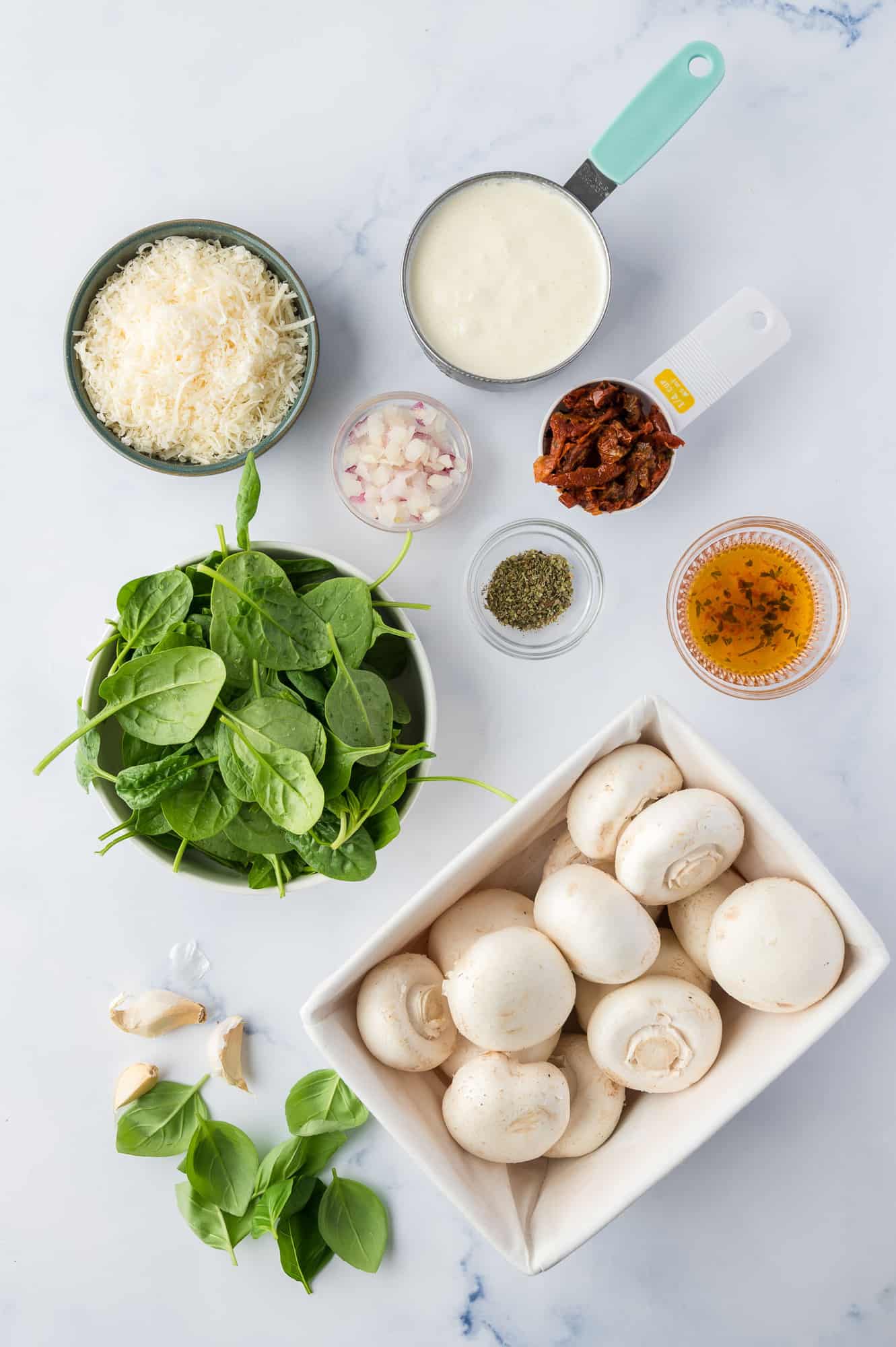 Overhead view of ingredients needed including mushrooms, spinach, and cheese.