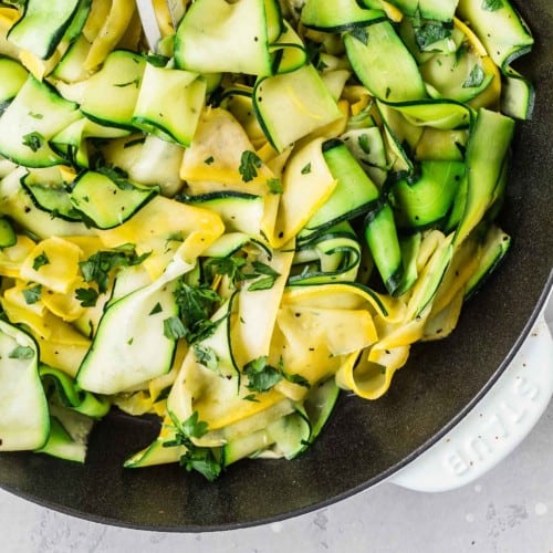 Zucchini ribbons in a pan with summer squash ribbons.