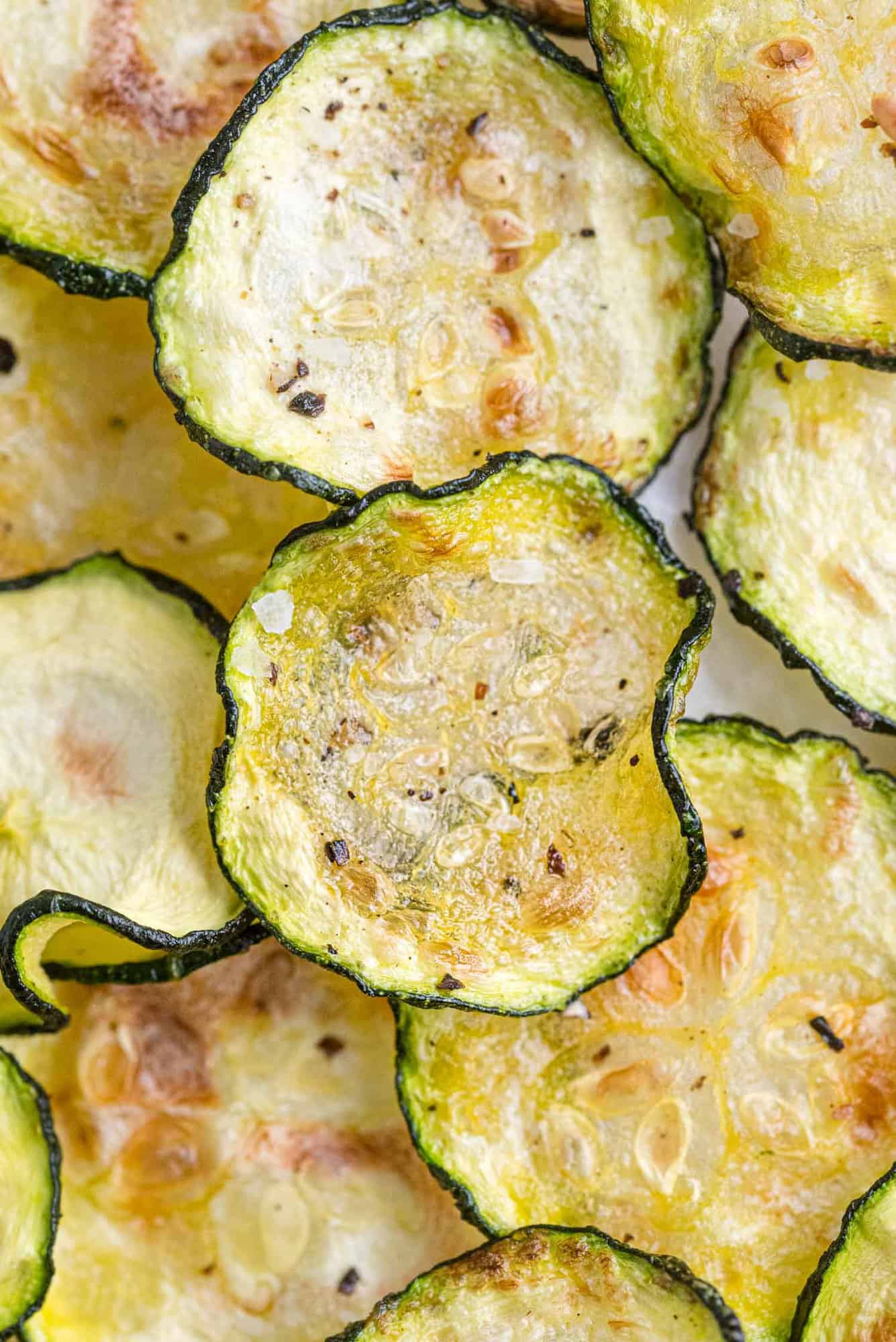 Overhead view of zucchini chips layered on top of each other. 