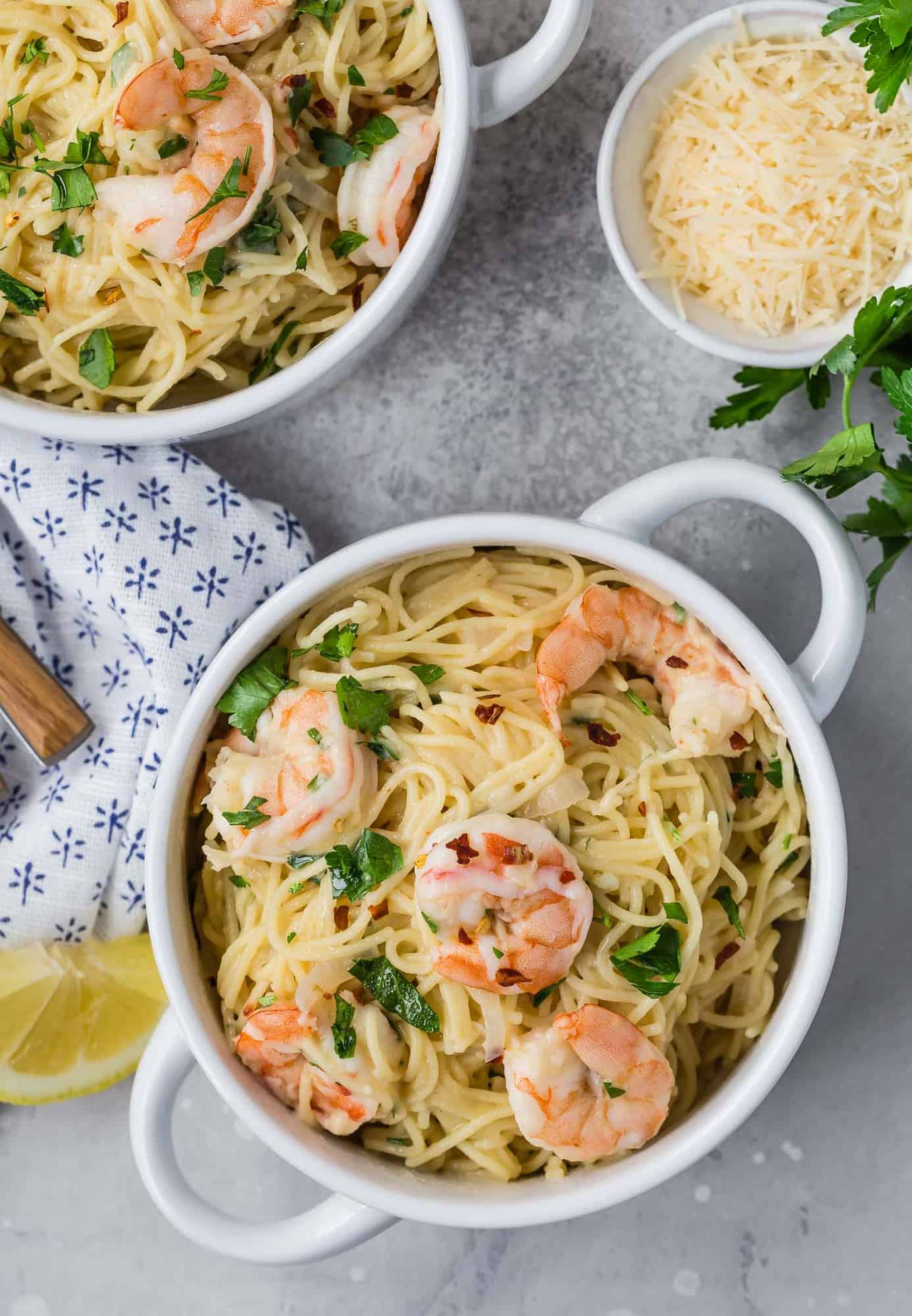 Overhead view of two bowls of shrimp pasta.