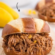 Pulled pork with text overlay that reads "mango bourbon pulled pork."