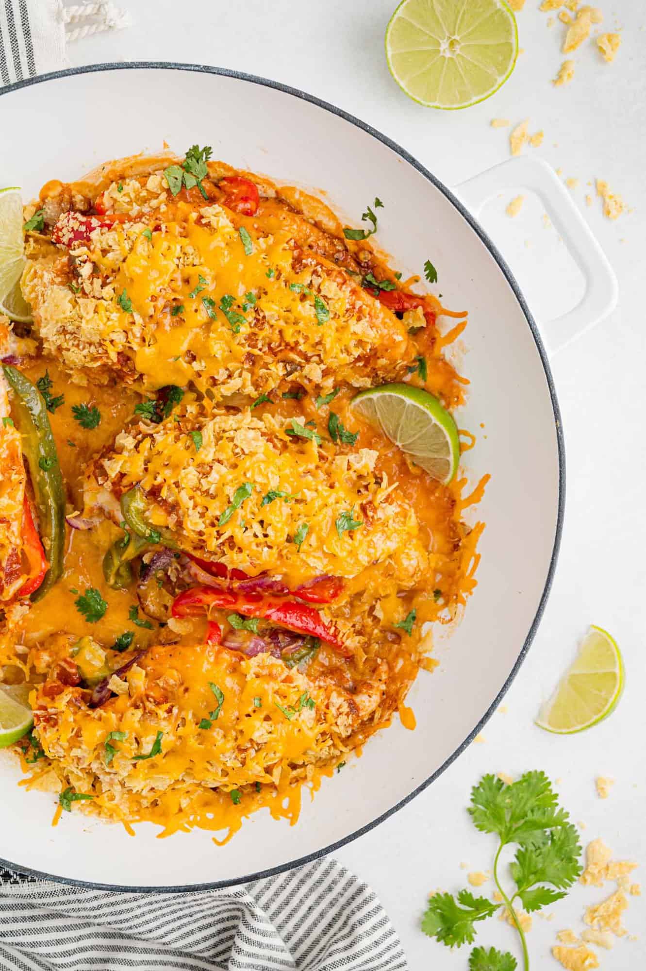 Overhead view of fajita stuffed chicken in a round baking dish.