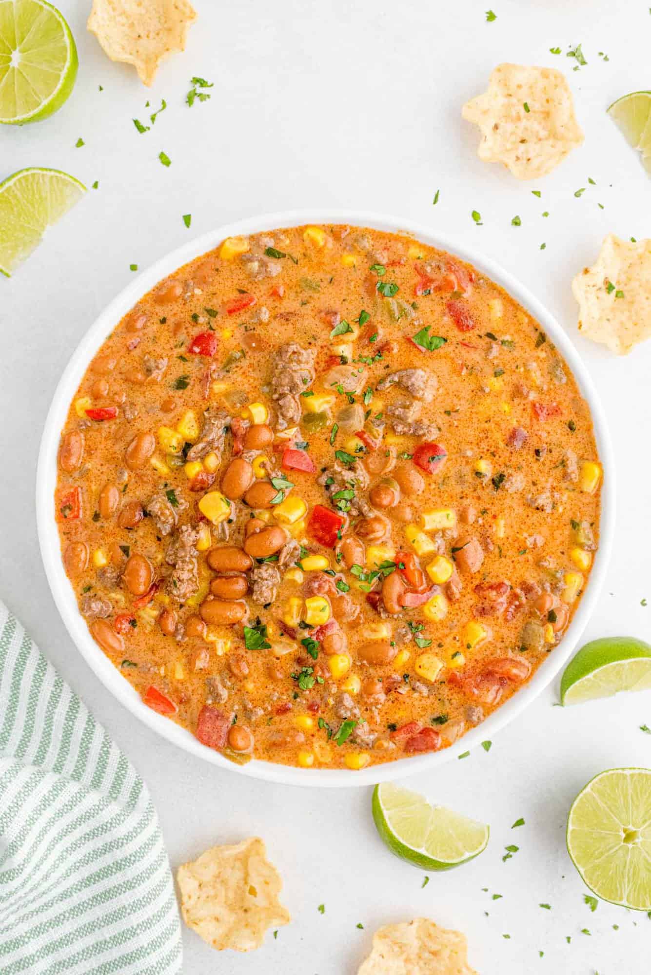 Overhead view of a large bowl of creamy chili topped with cilantro.