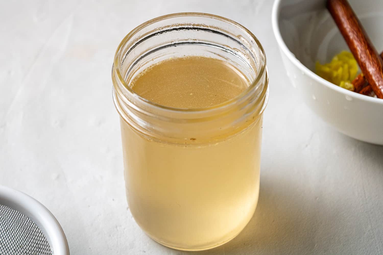 Ginger cinnamon simple syrup in a small jar.