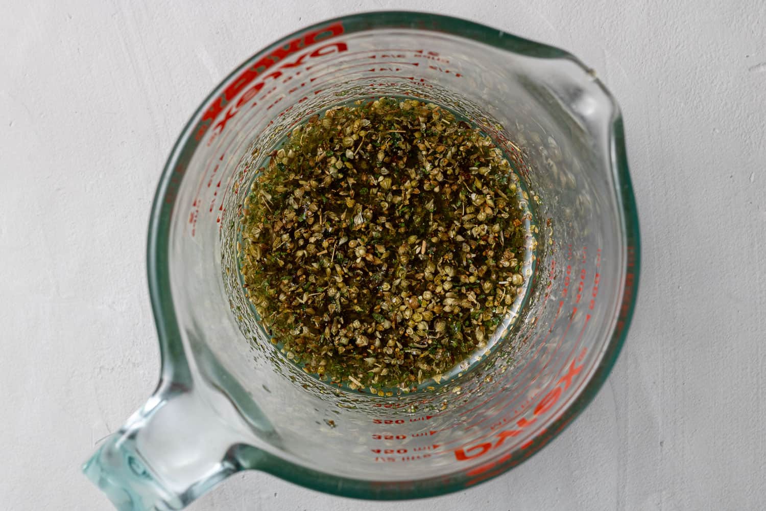 Italian vinaigrette in a small measuring cup.