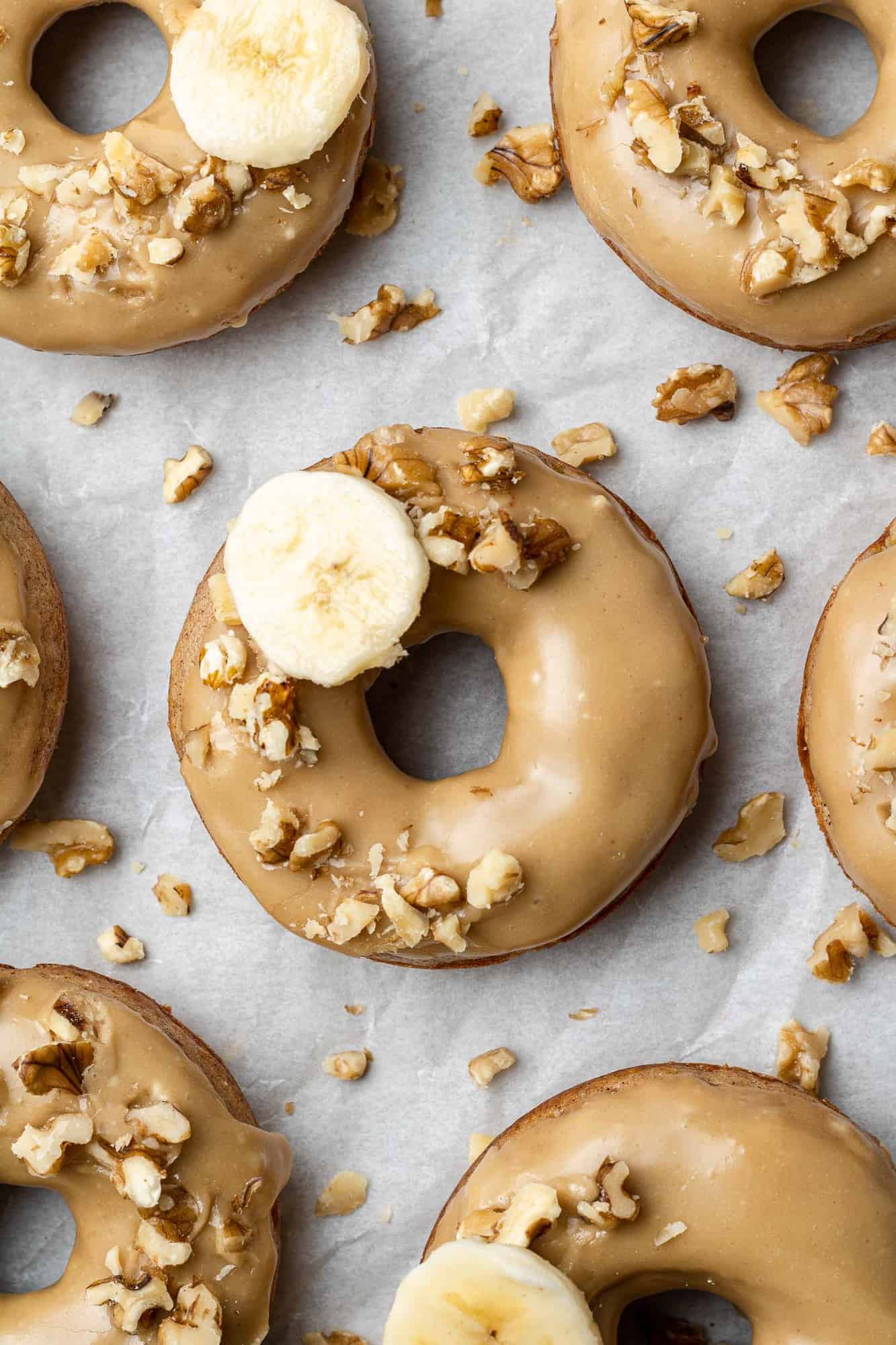 Banana donuts with a brown sugar glaze, topped with walnuts.