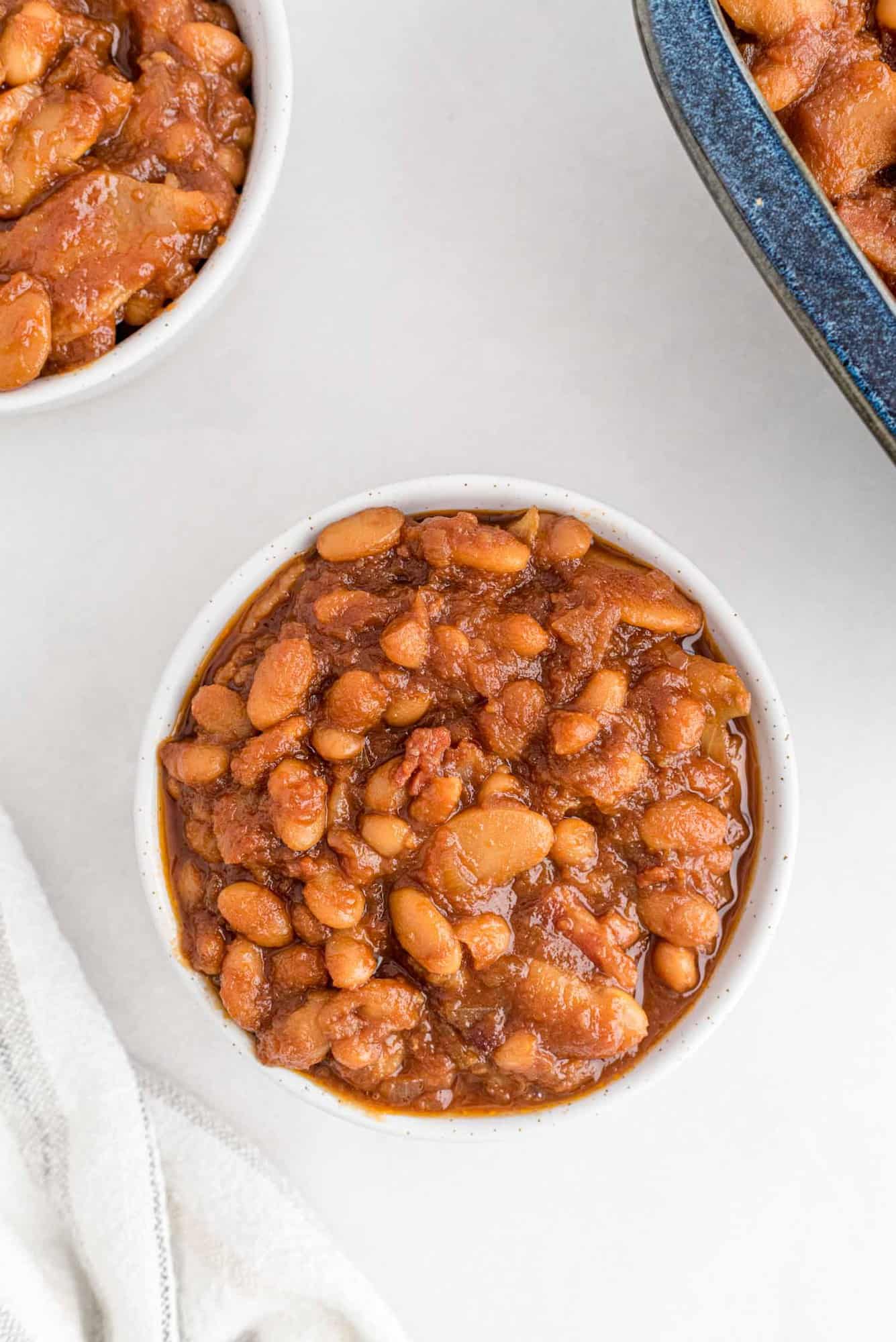 Baked beans in a small white bowl.