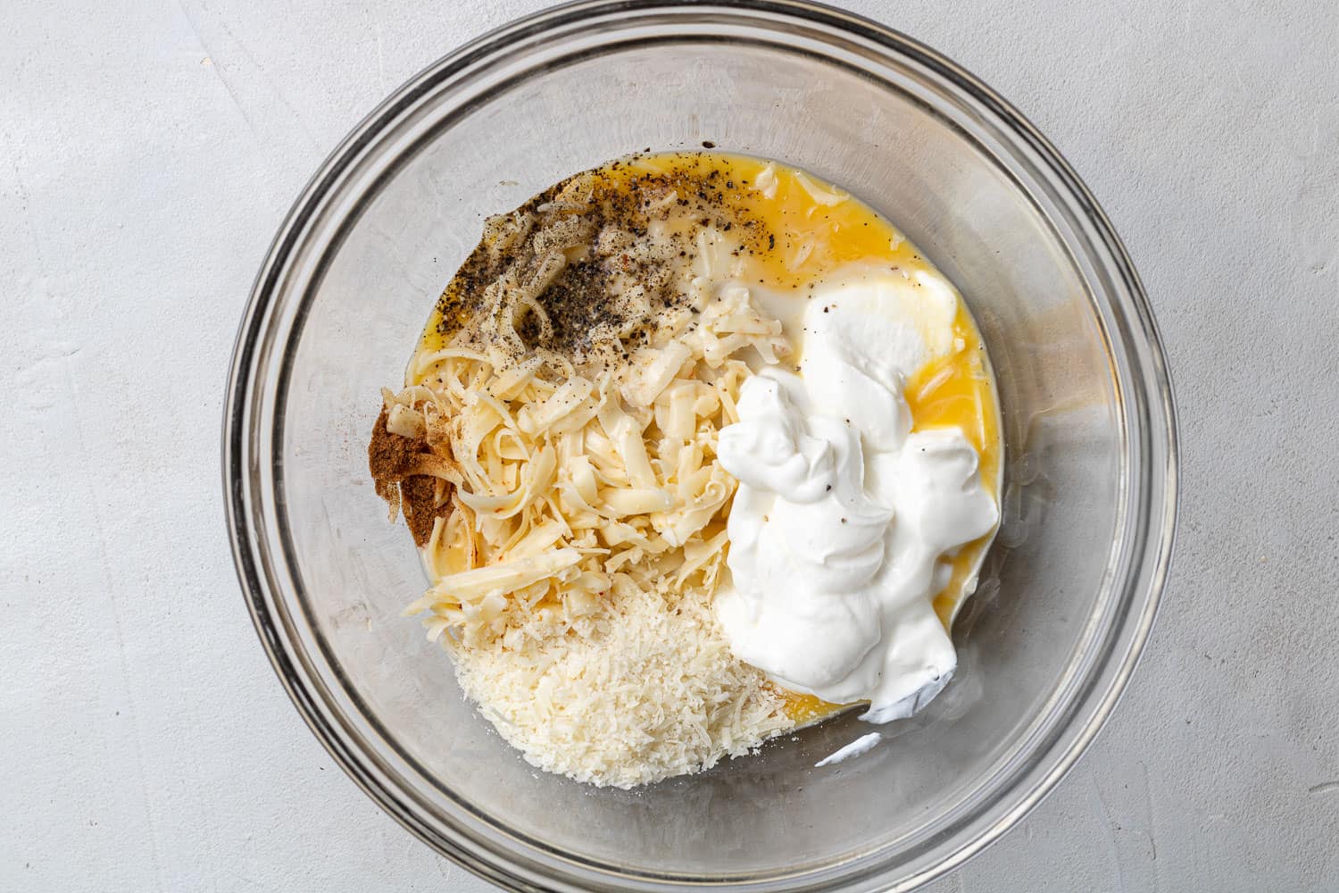 Ingredients in a clear glass mixing bowl.