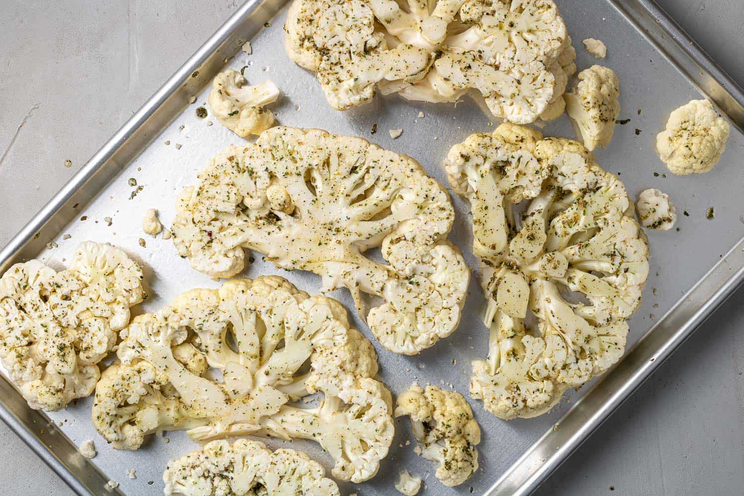 Seasoned, but uncooked, slices of cauliflower.