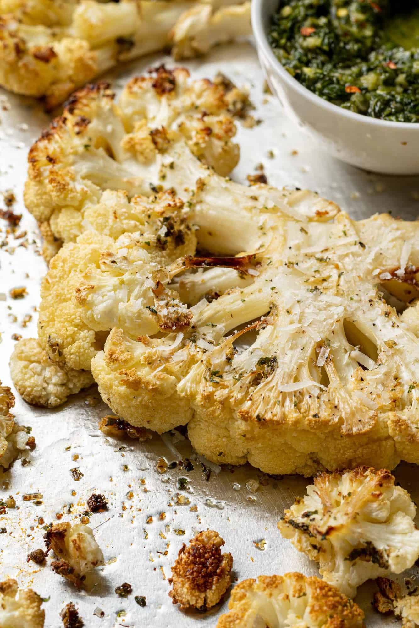 Close up of a thick slice of cauliflower that has been roasted.