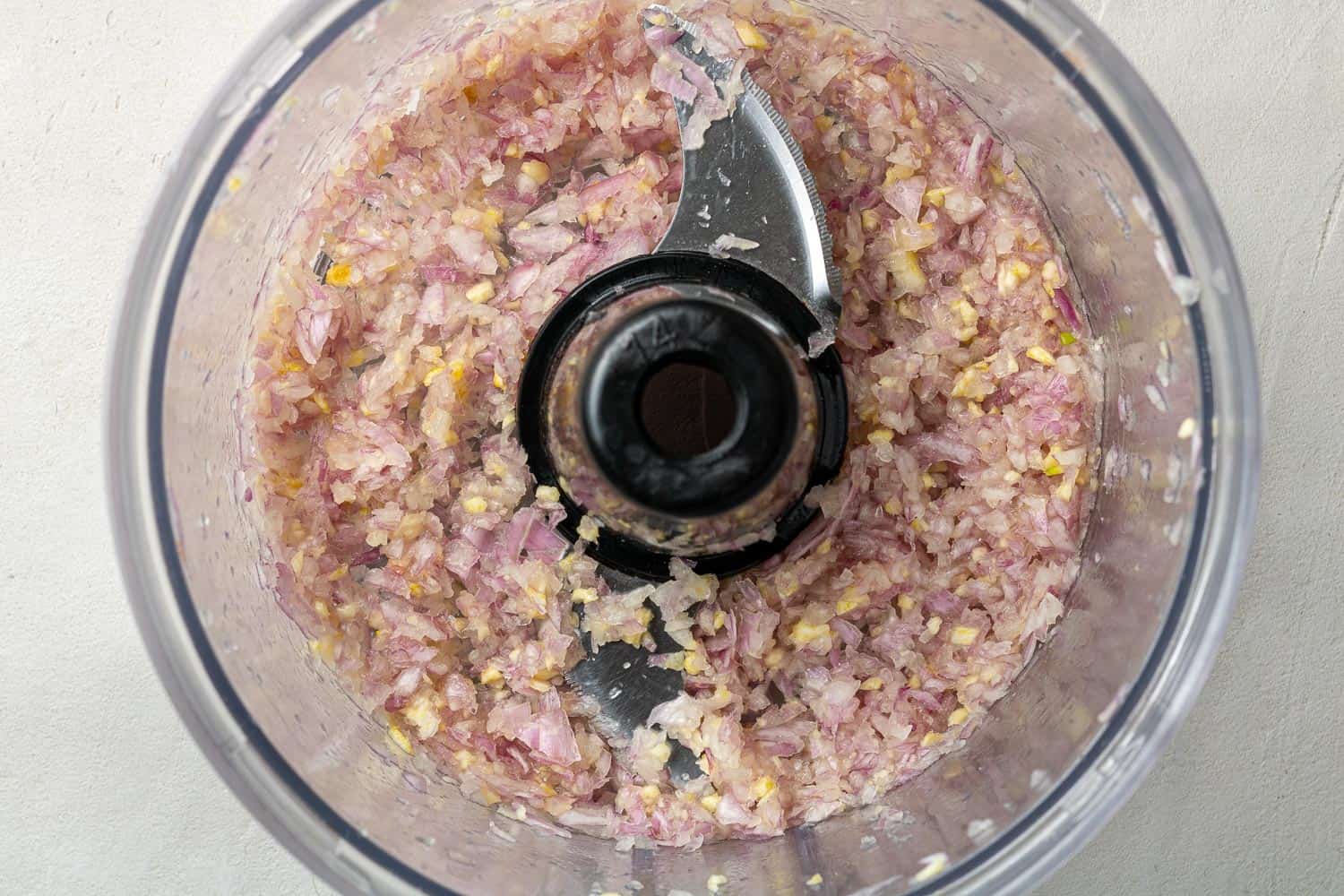 Onions and garlic in a food processor.