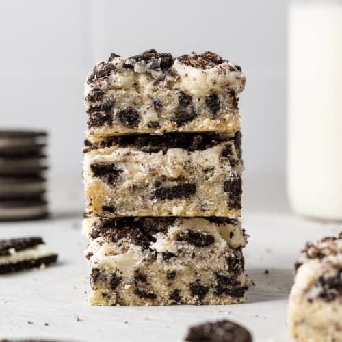 Stack of three frosted oreo cookie bars.