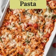 Pasta with cheese and pizza sauce, text overlay reads "pizza baked pasta."