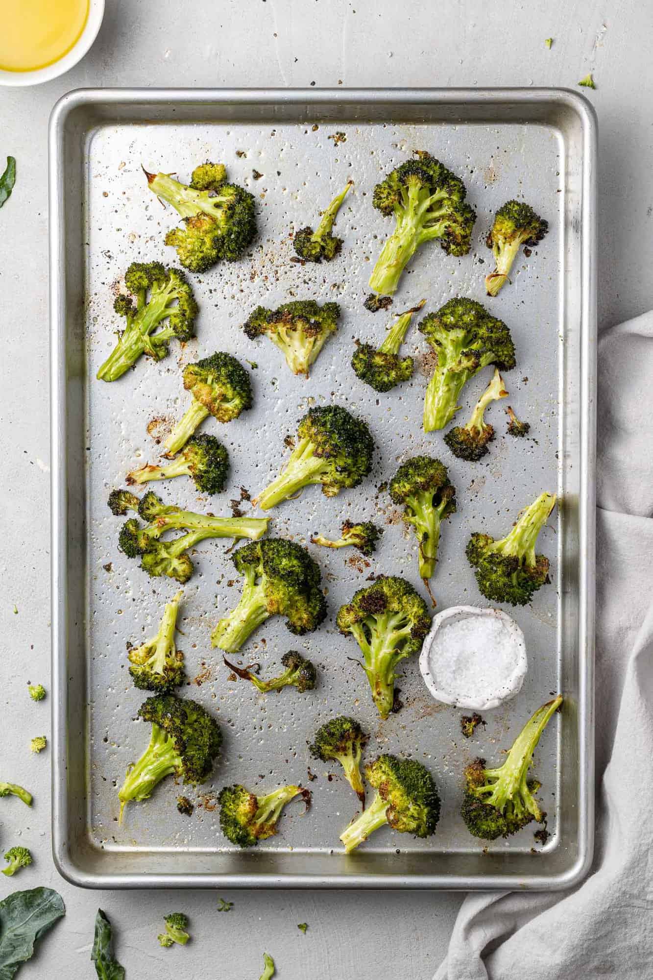 Overhead view of sheetpan full of roasted broccoli.