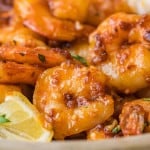 Close up of cooked shrimp with spicy honey sauce and bits of crunchy garlic.