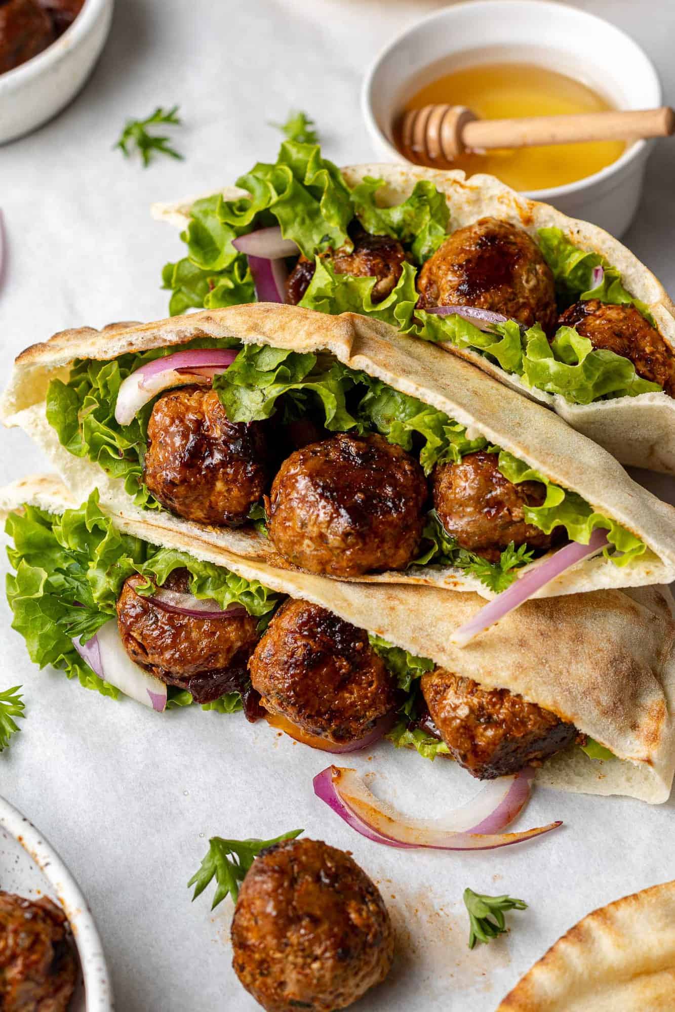 Meatball pitas with onion and lettuce.