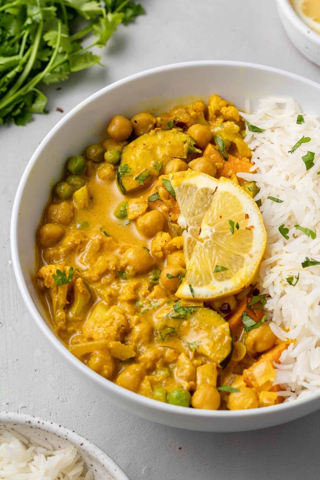 Chickpea curry with rice in a white bowl.