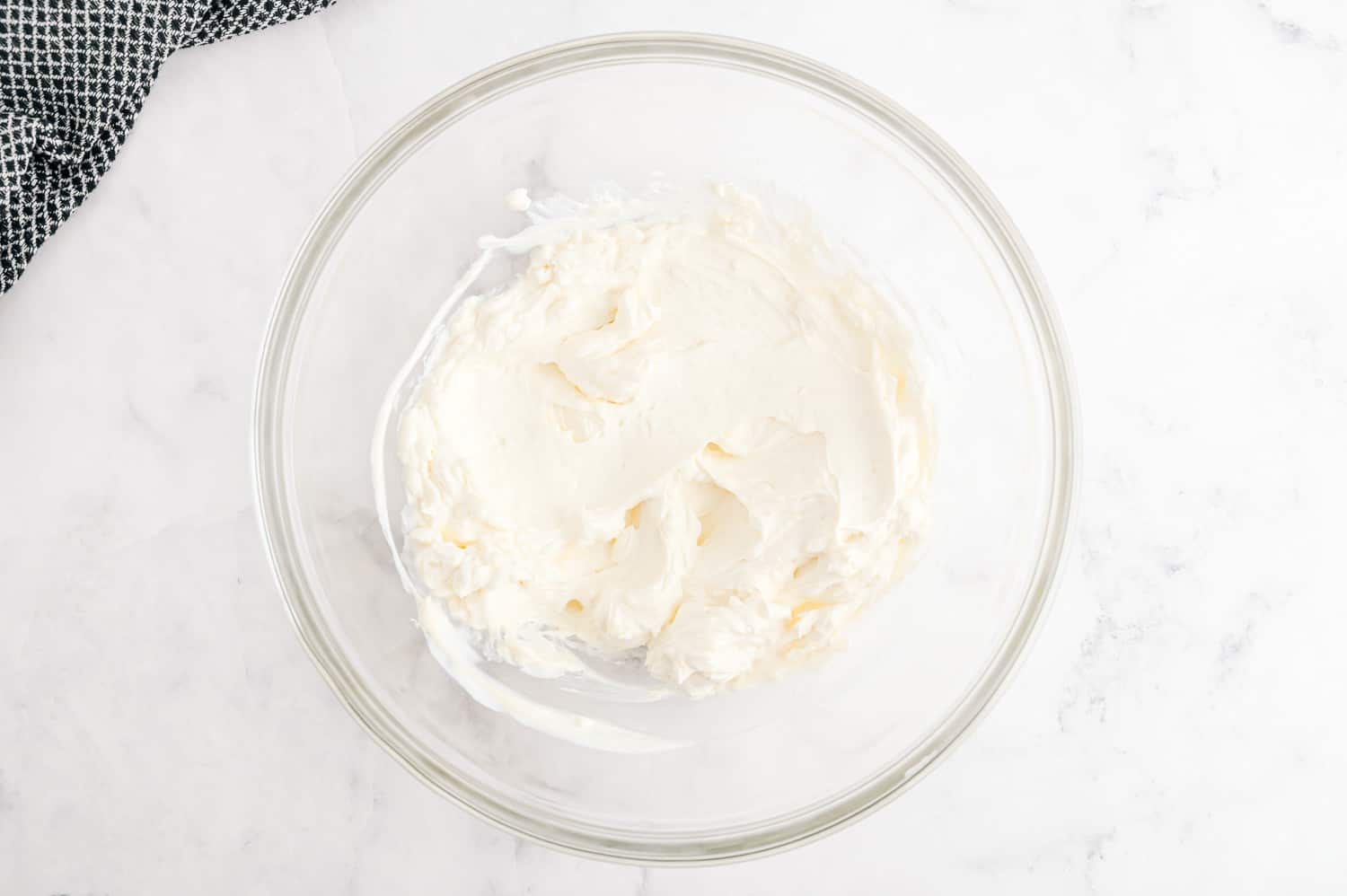 Creamy ingredients in a glass mixing bowl.