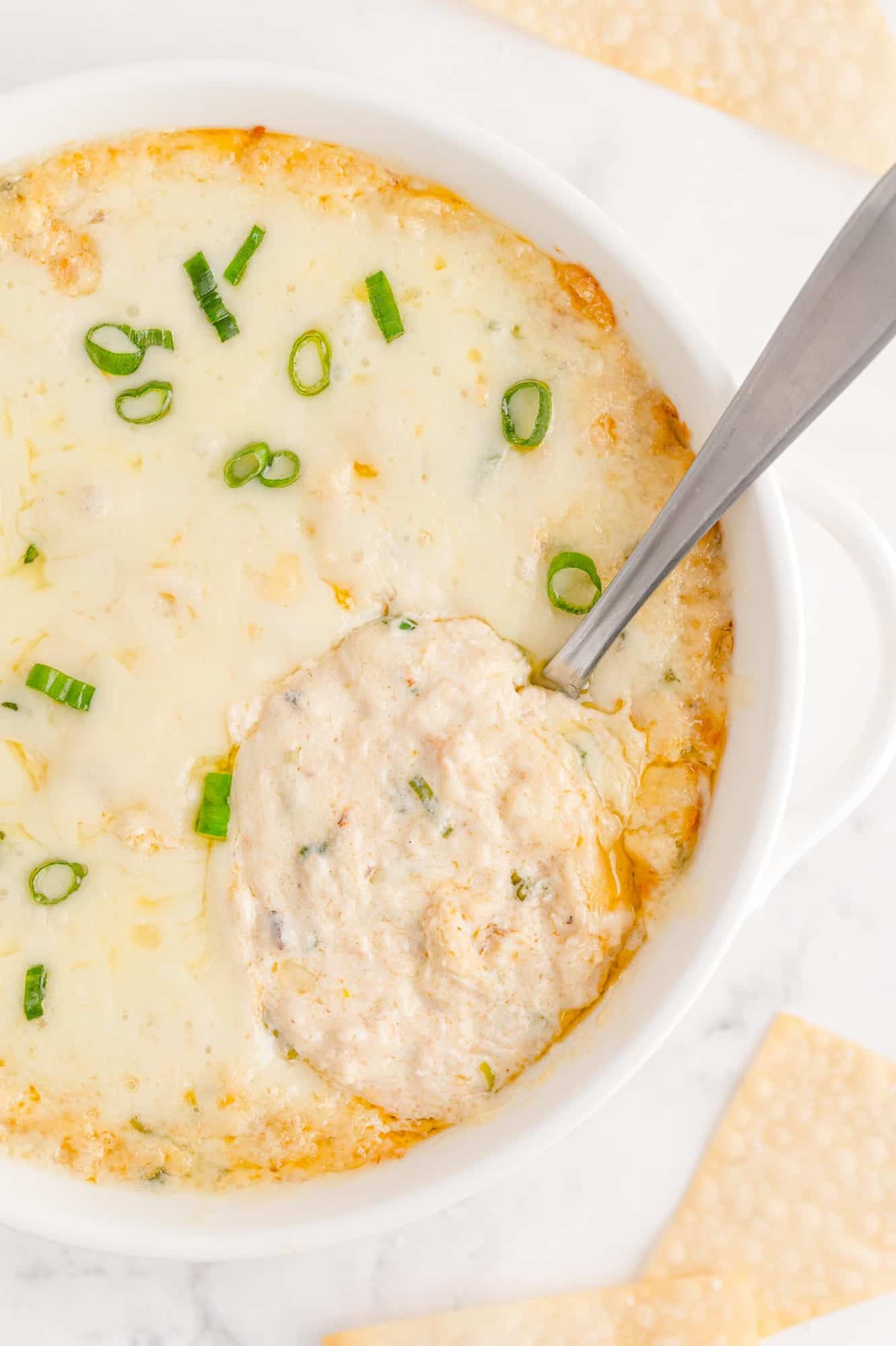 Crab rangoon dip with spoon to show texture.