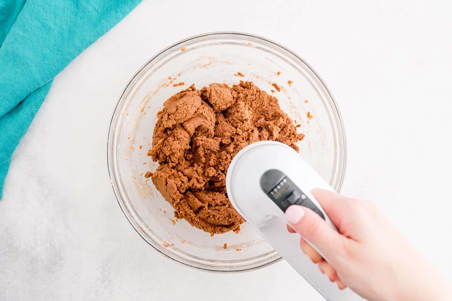 Chocolate cookie dough being mixed.