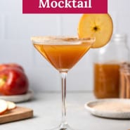 Brown drink in martini glass, text overlay reads "ginger apple cider mocktail."