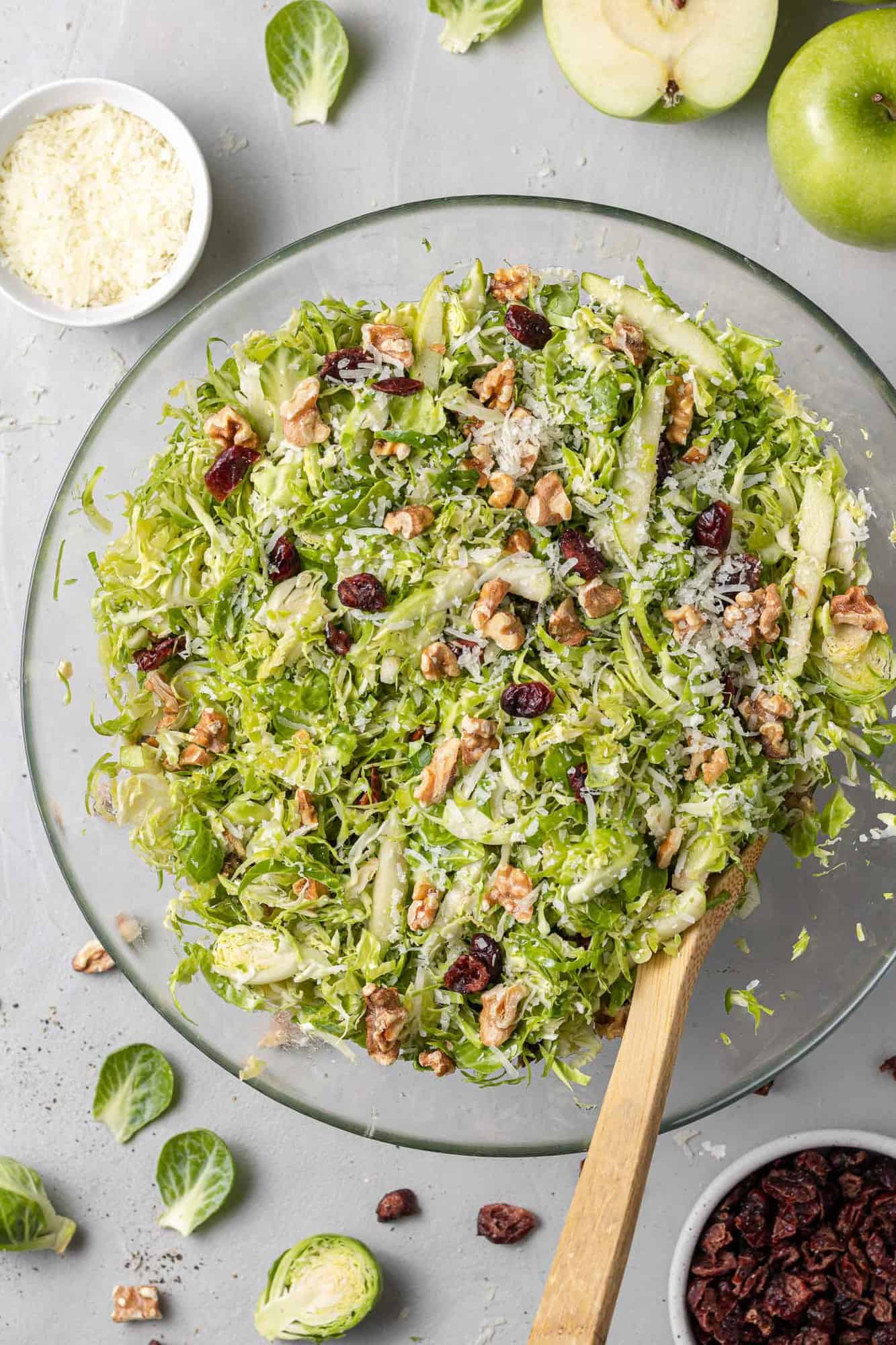 Overhead view of a shredded brussels sprouts salad with cranberries, walnuts, green apples.