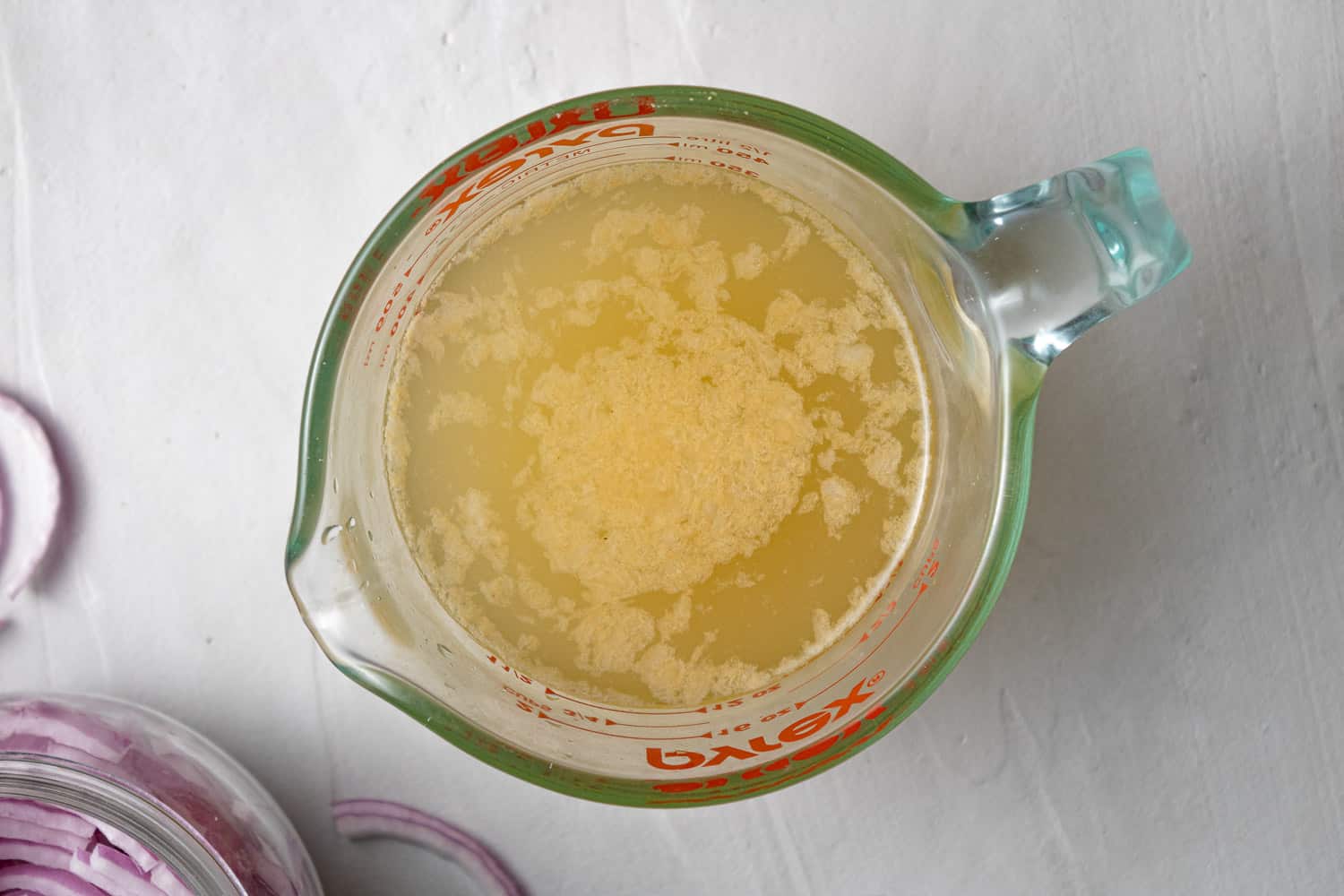 Pickling liquid in a glass measuring cup.