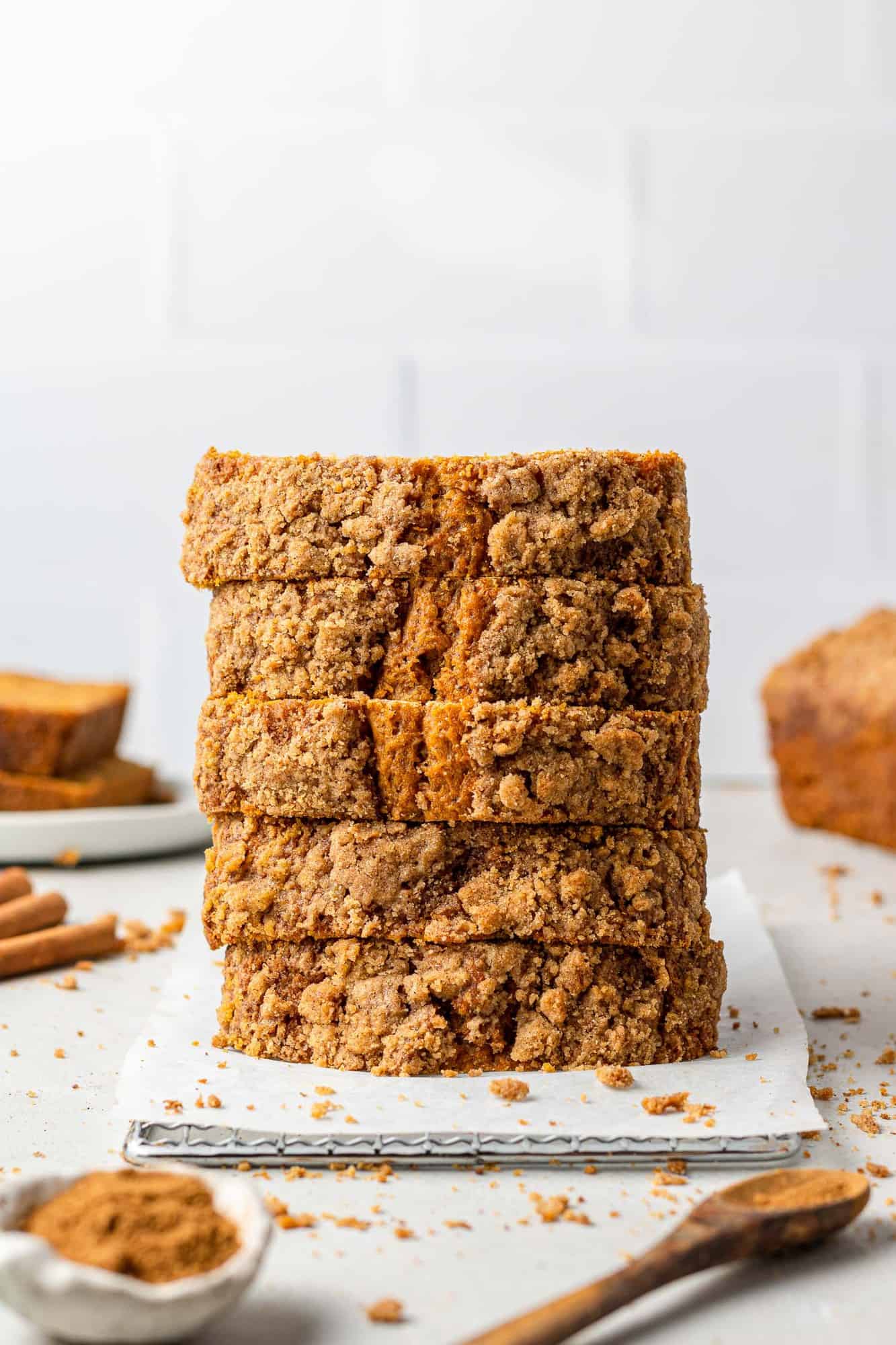 Stack of pumpkin bread slices, with spices around.