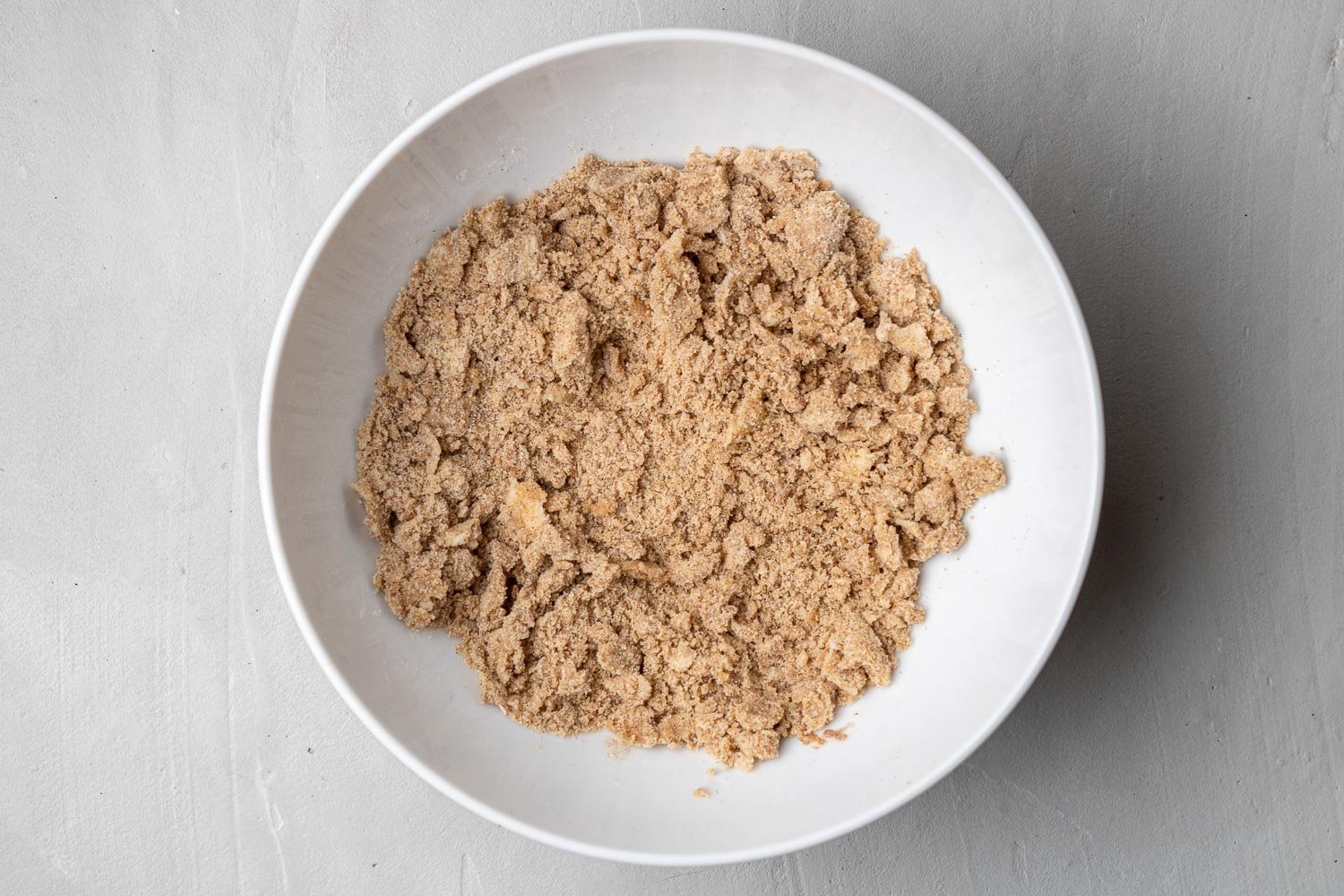 Streusel topping in a small white bowl.