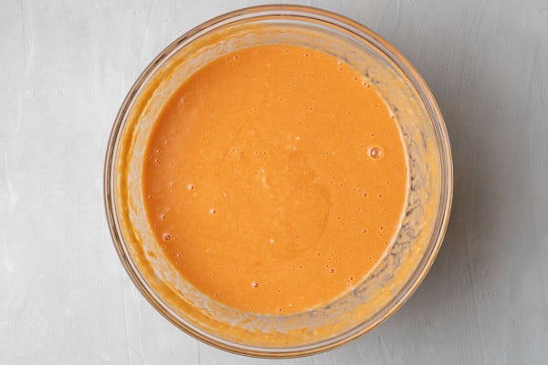 Wet ingredients in a clear glass mixing bowl.