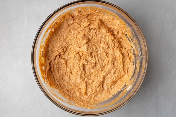 Pumpkin bread batter in a clear glass bowl.