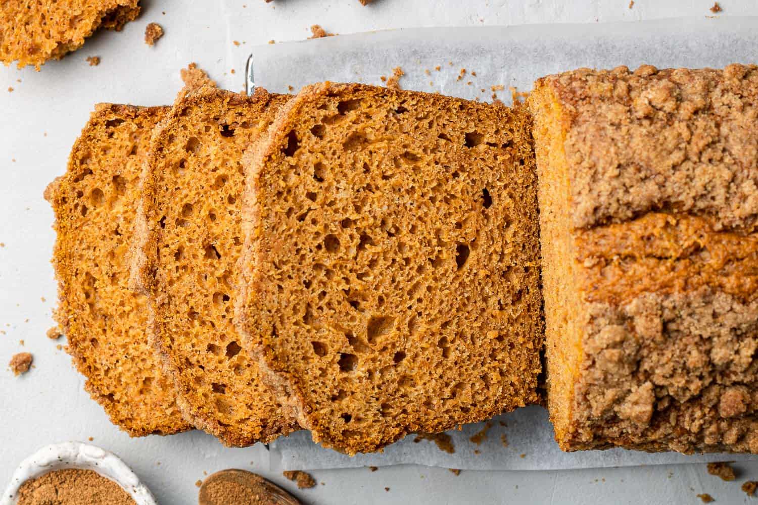 Cooked bread, partially sliced.