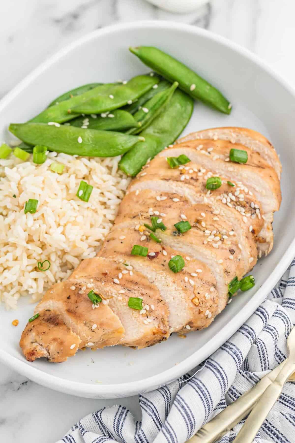 Chicken flavored with Asian chicken marinade, cooked on a plate.