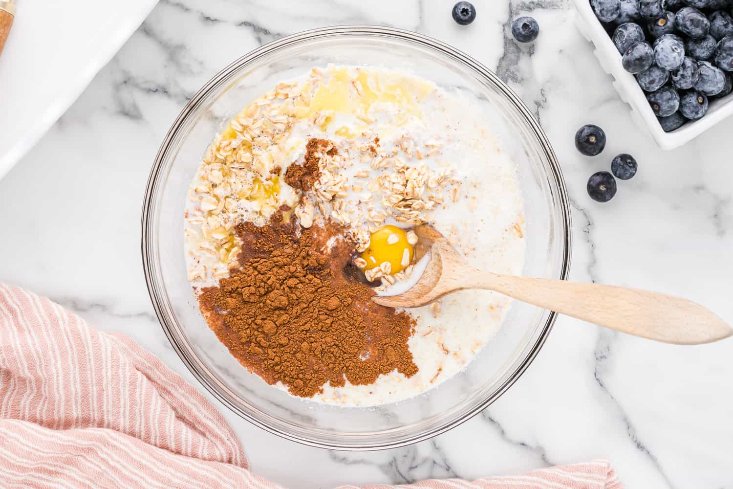 Unmixed ingredients in a clear glass bowl.