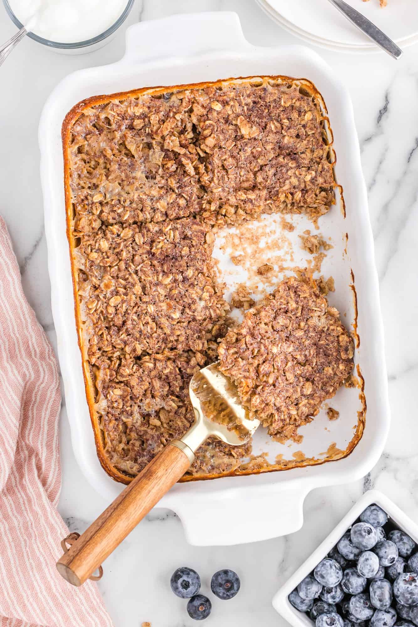 Square of baked oatmeal being removed from baking dish.