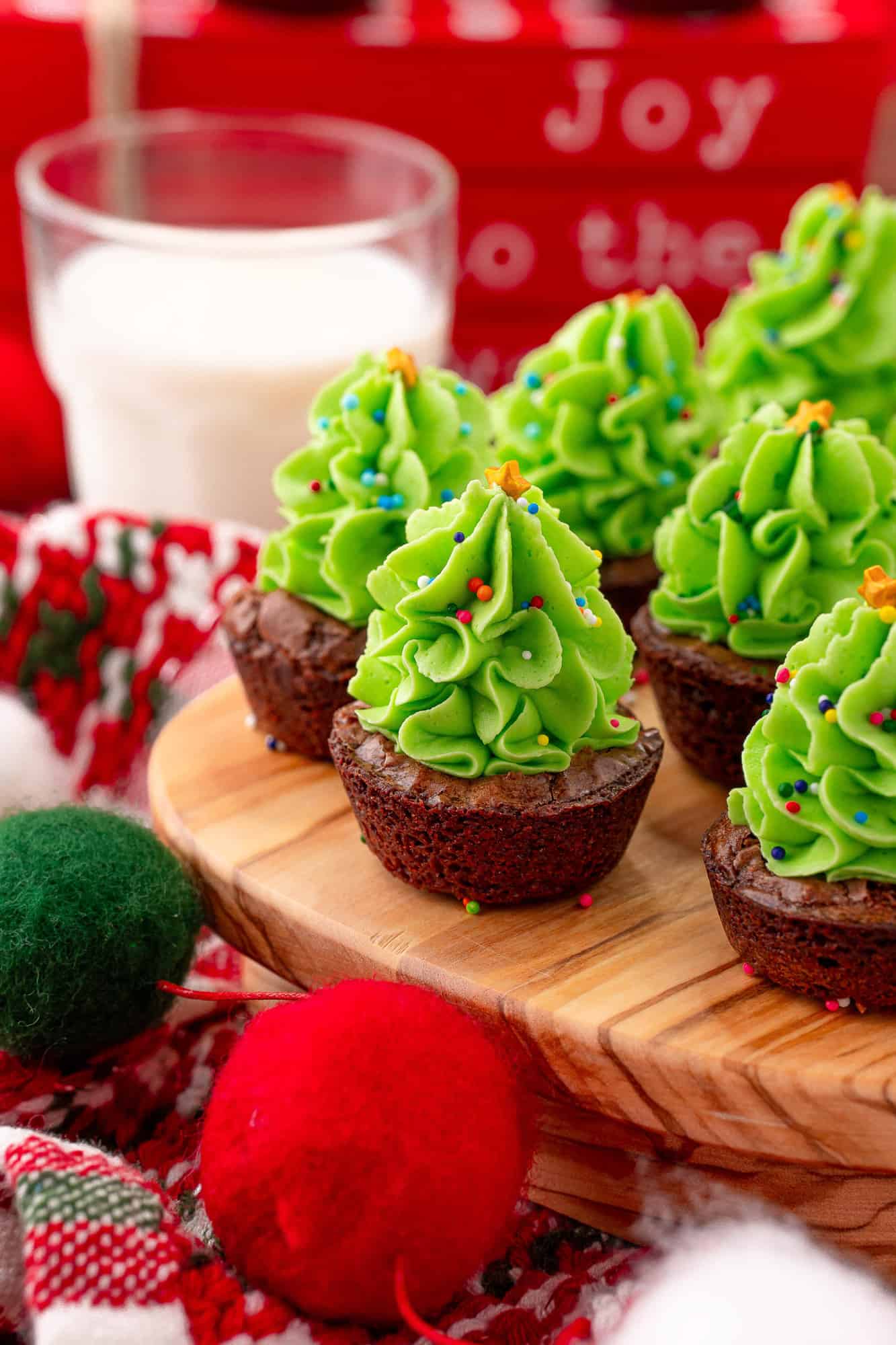 Mini brownies topped with frosting to look like christmas trees.