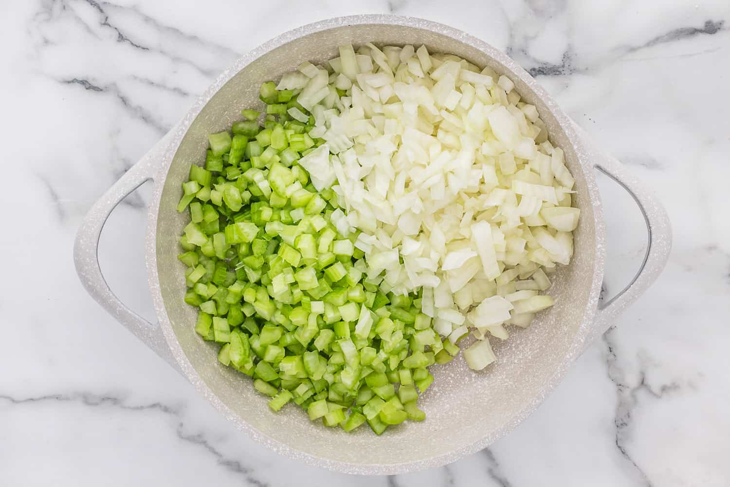 Onions and celery in a pan.