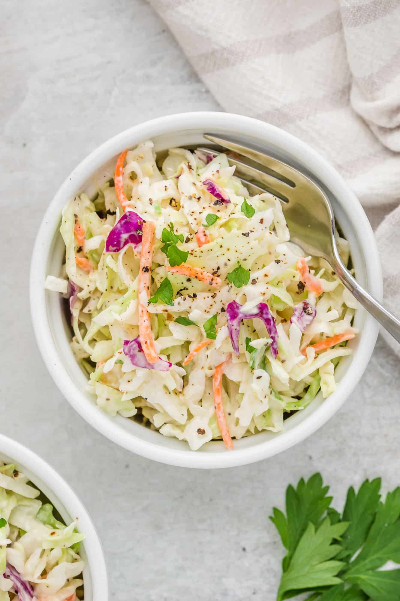 low-fat-coleslaw Overhead view of healthy coleslaw in a small round bowl.
