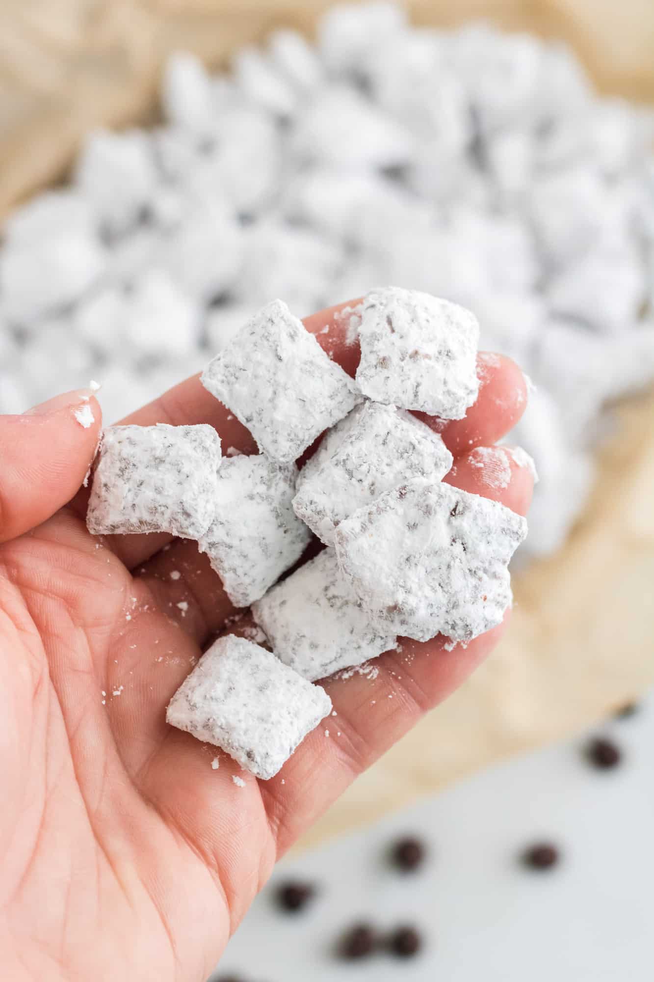 Puppy chow dessert being held in a hand.