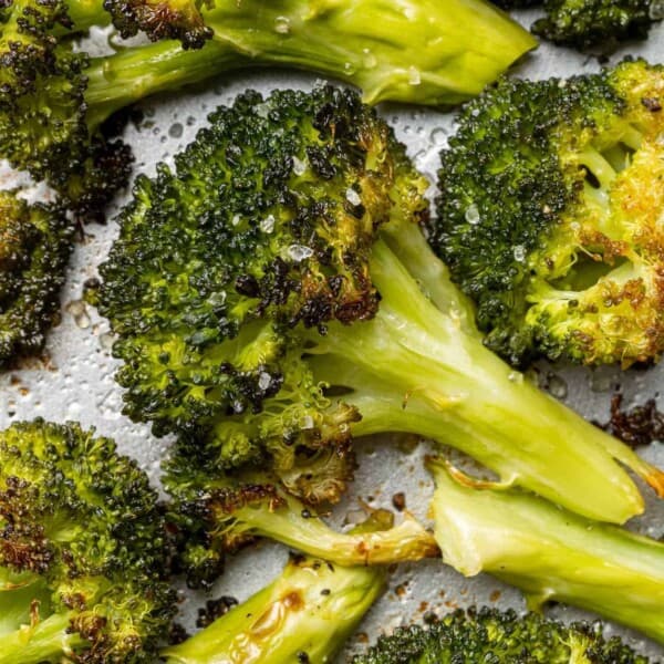 Close up of roasted broccoli floret, surrounded by others.