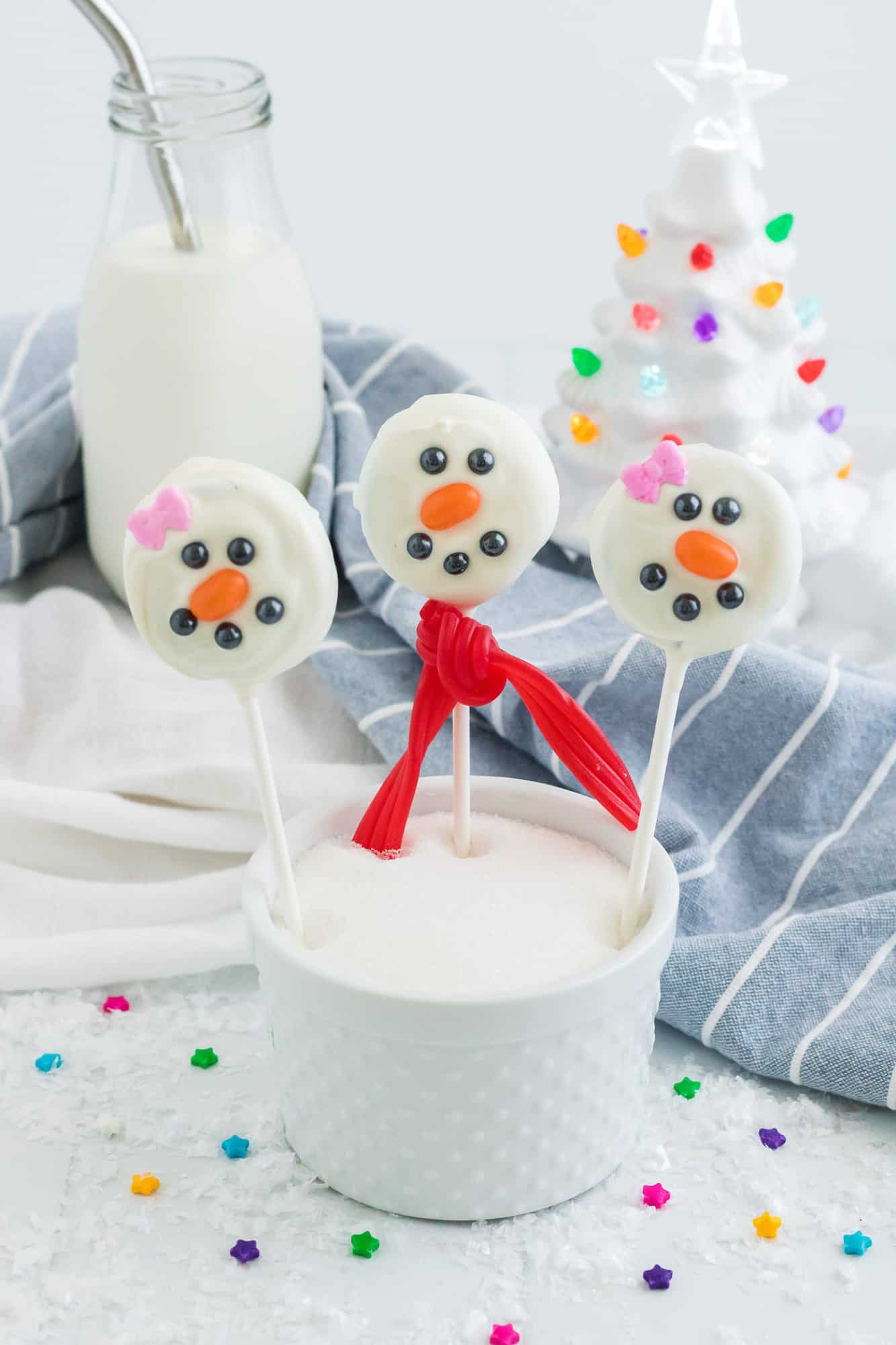 Snowmen pops in a cup of sugar.
