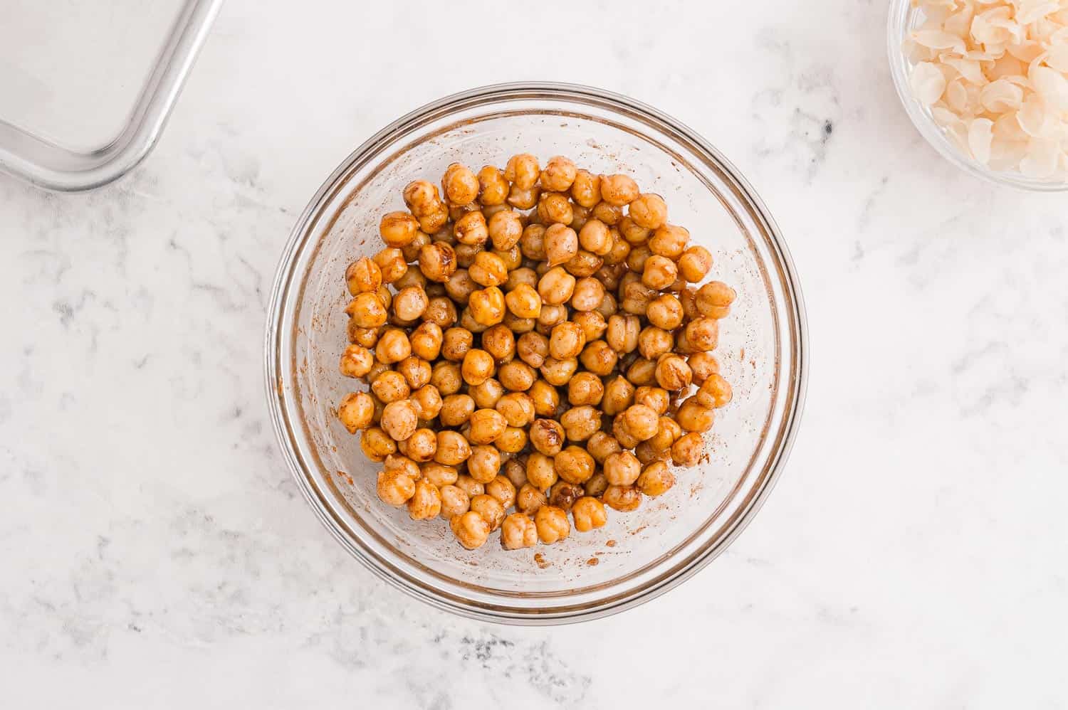 Chickpeas in a bowl with cinnamon and coconut oil.