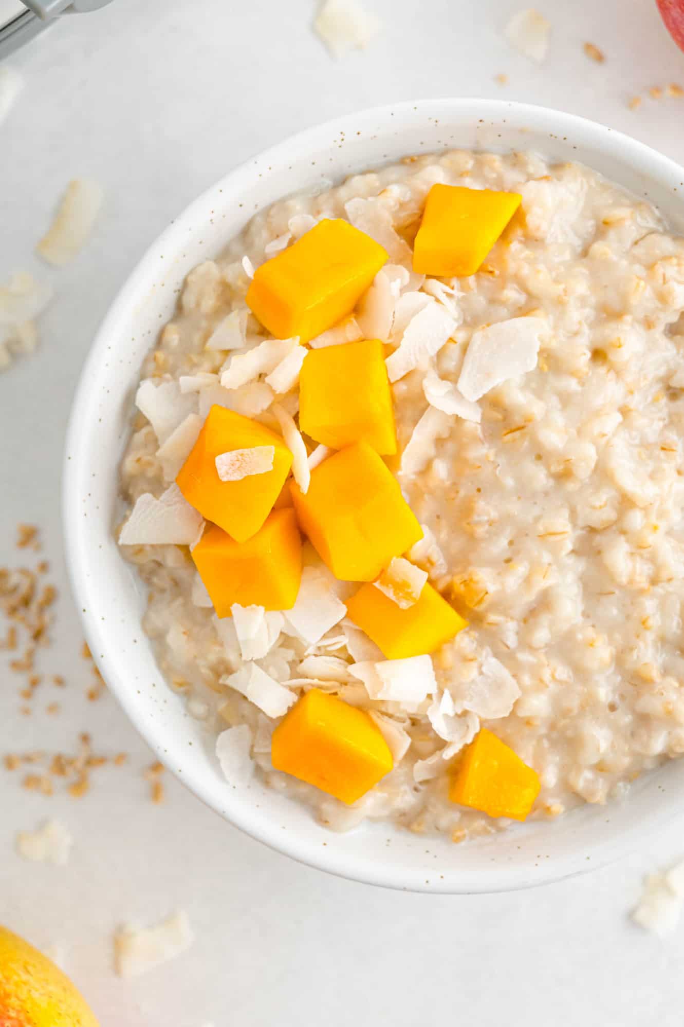 Oatmeal topped with mango and coconut.