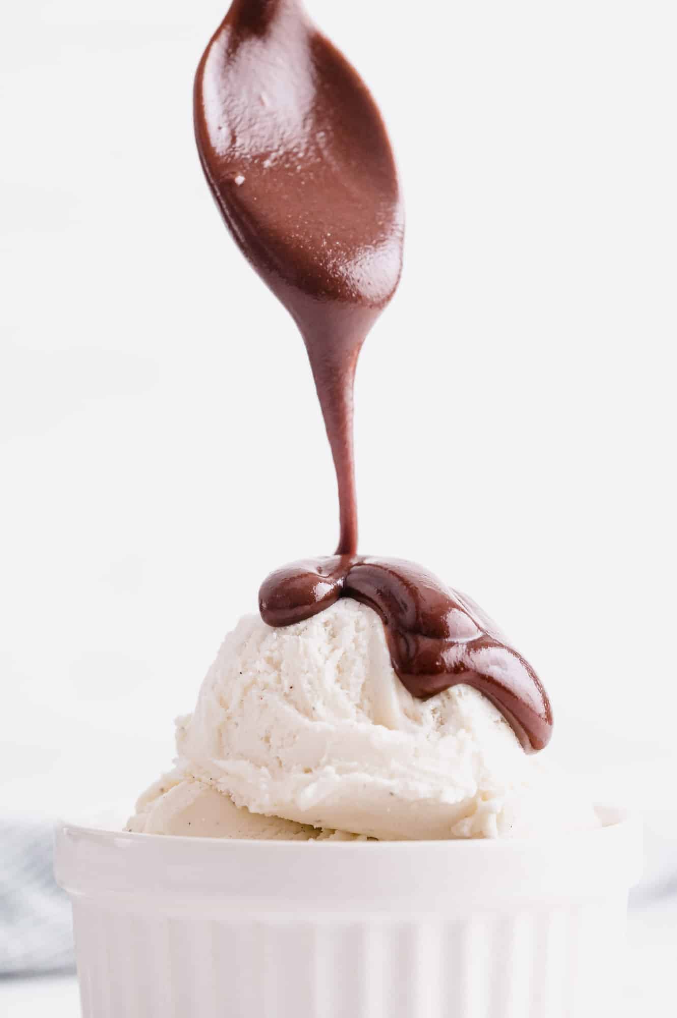 Homemade hot fudge being poured on ice cream.