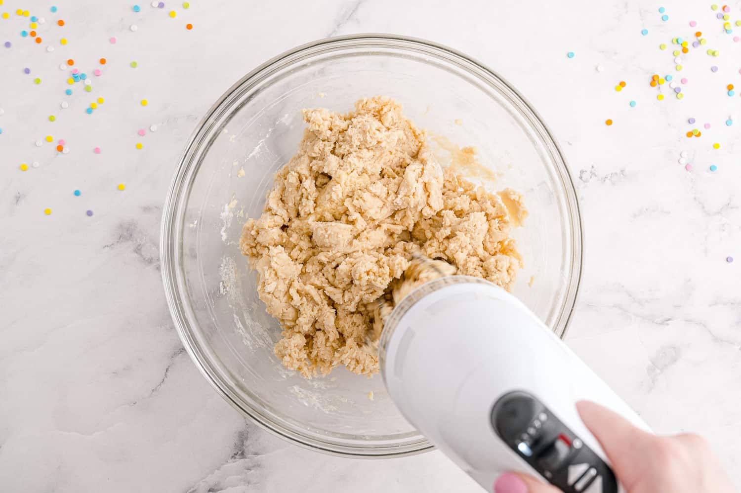 Ingredients being mixed with an electric mixer.