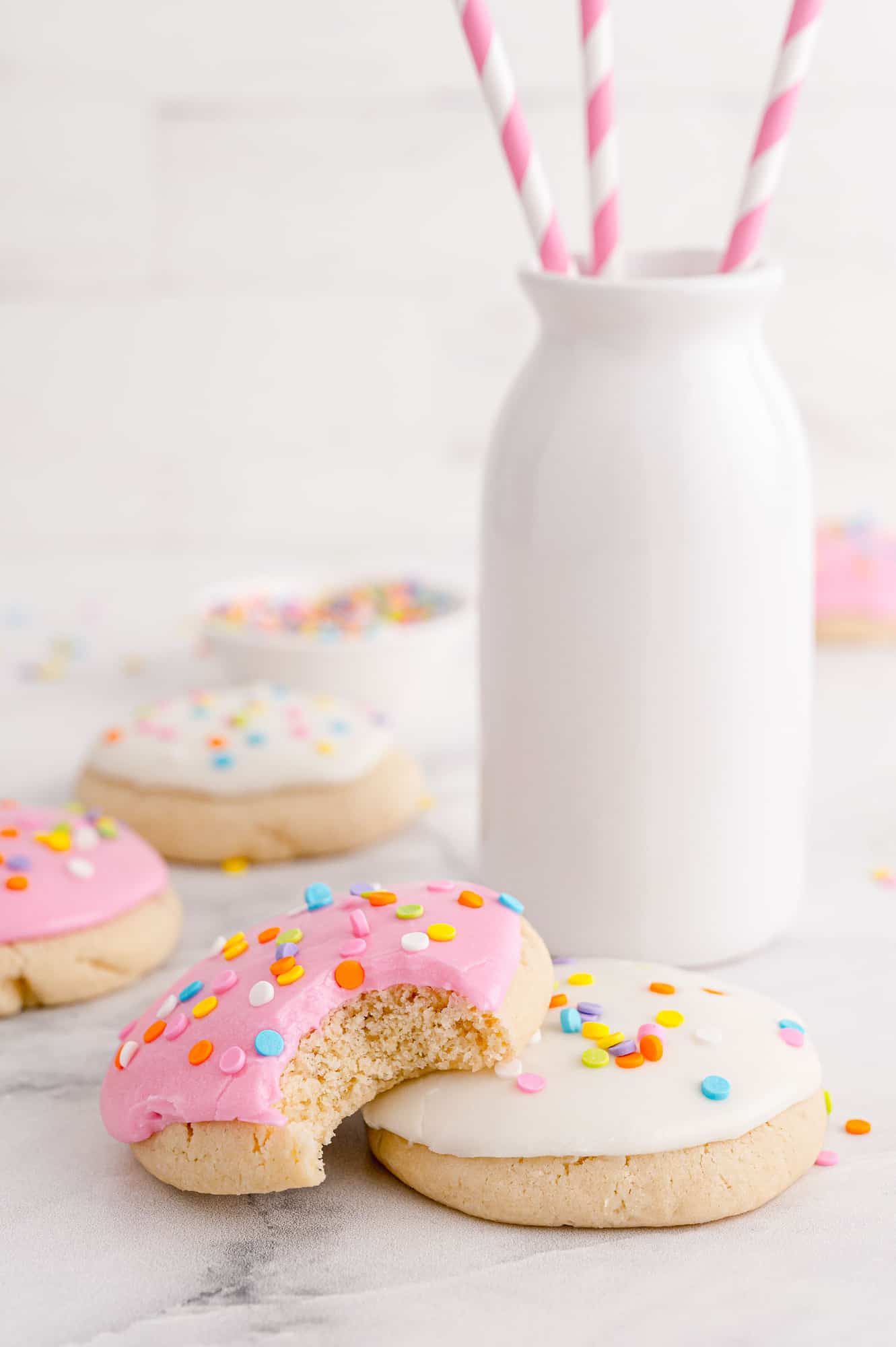 Cookies with milk in background.