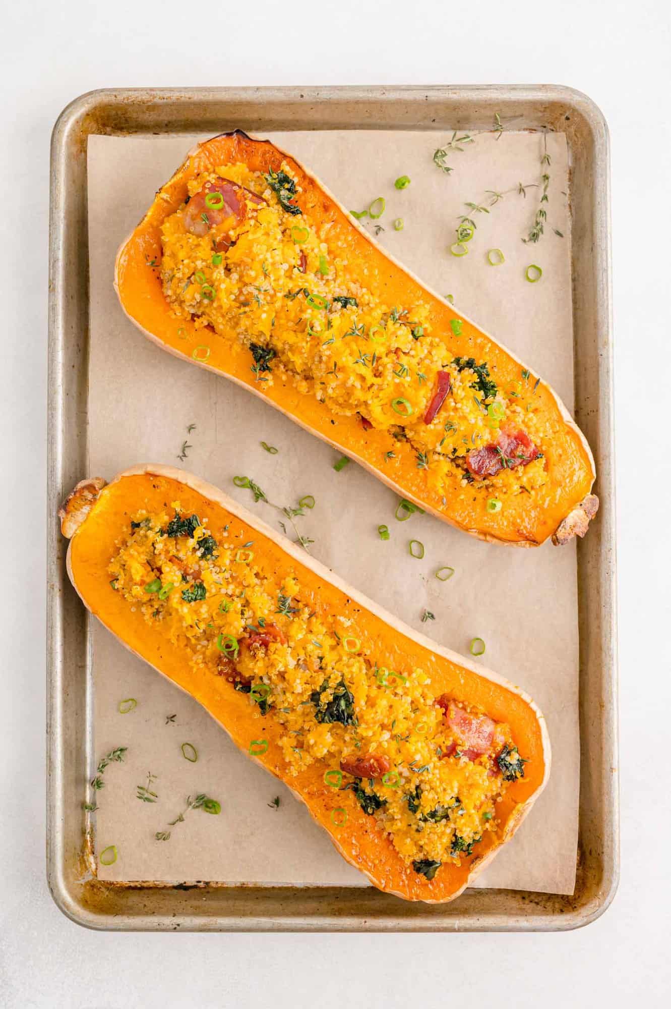 Overhead view of two stuffed butternut squash halves.