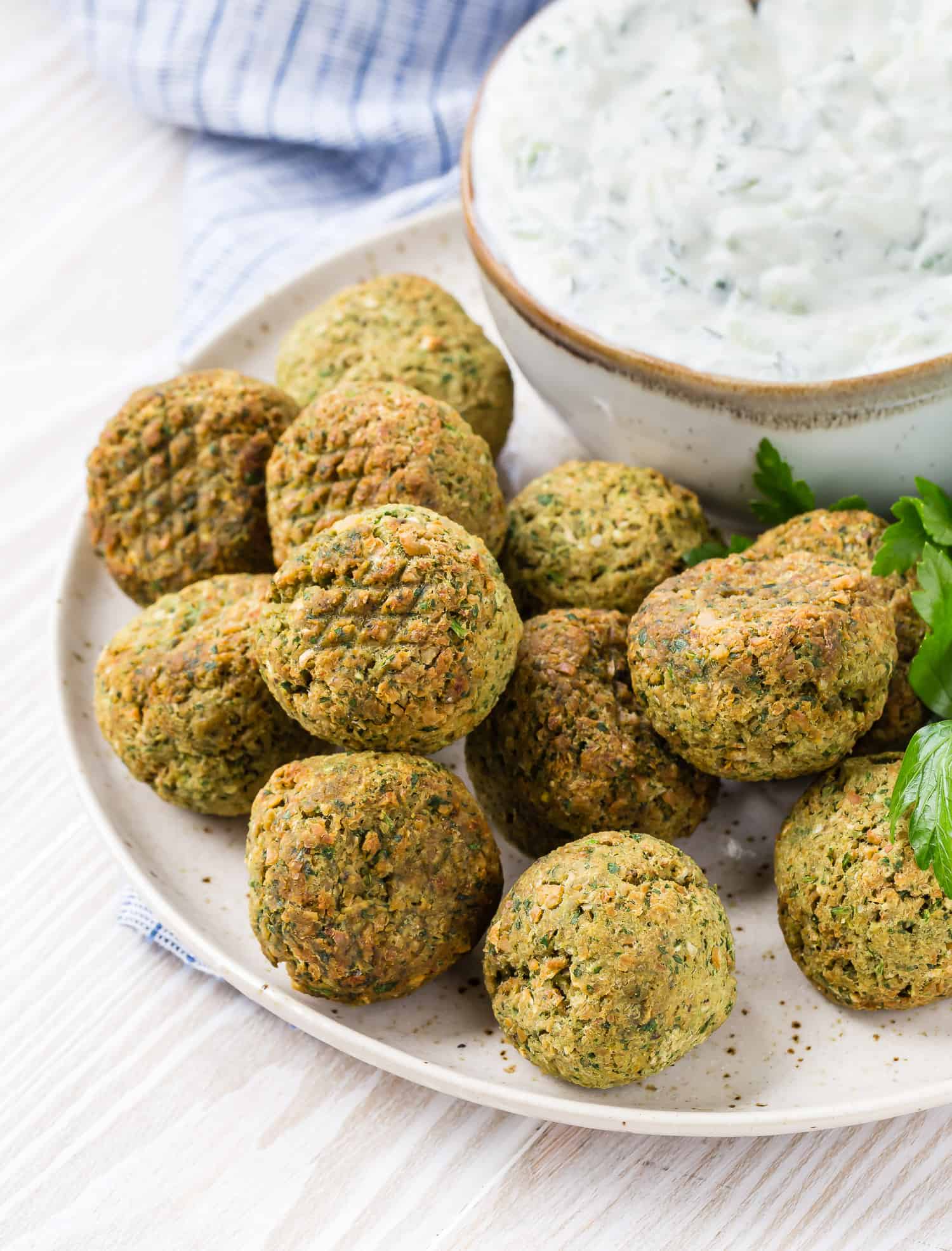 Falafel on a plate with tzatziki.