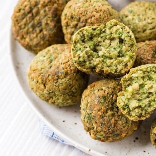 Split-open chickpea fritter made in the air fryer. Flecks of herbs are visible.