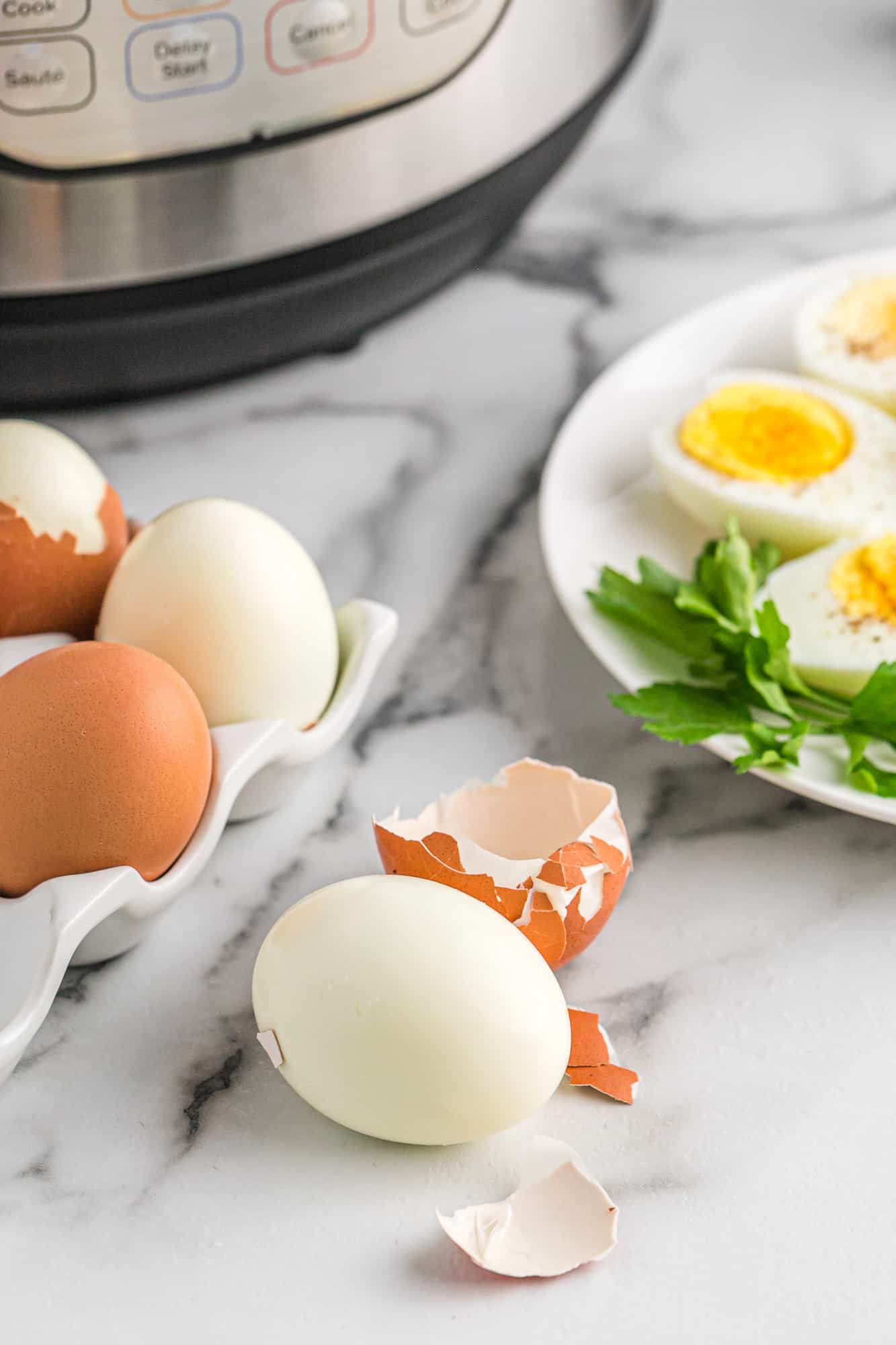 Boiled egg with shell removed, more eggs in background.